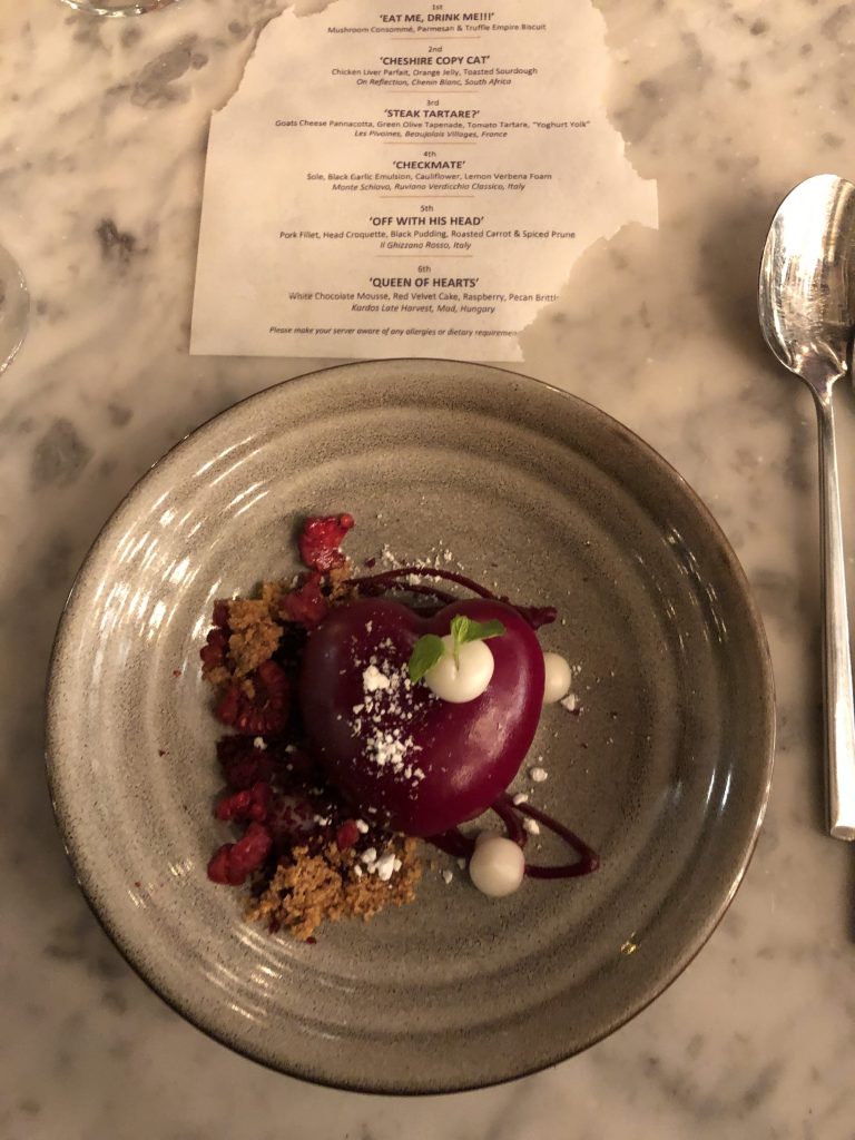 White Chocolate Mousse, Red Velvet Cake, Raspberry, Pecan Brittle.